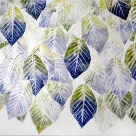 A sheet of white paper printed with blue and green leaves. 