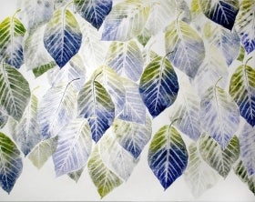 A sheet of white paper printed with blue and green leaves. 