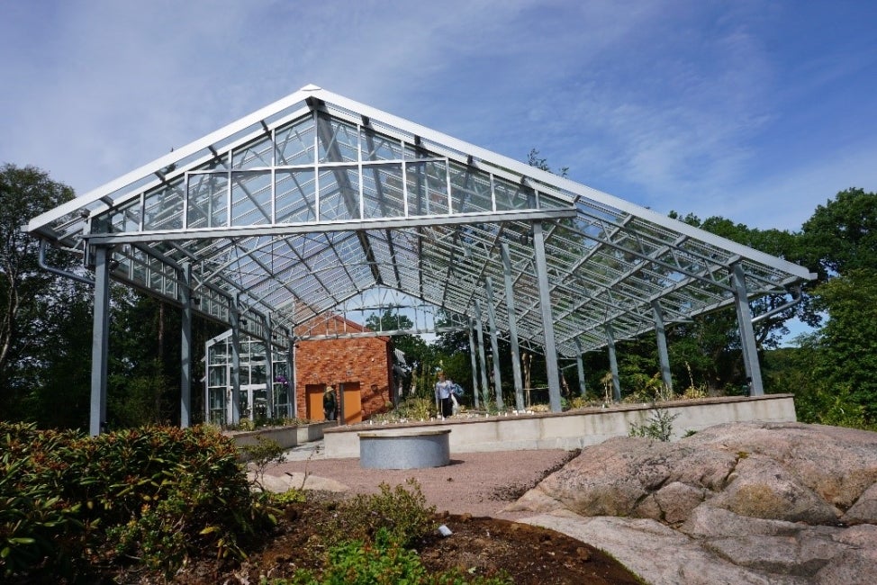 A glasshouse on a sunny day with blue skies. 