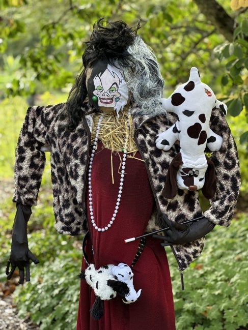 A scarecrow designed to look like Cruella de Vil.